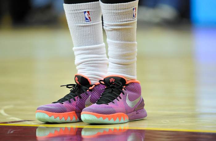 View of Kyrie Irving's purple and orange Nike shoes.